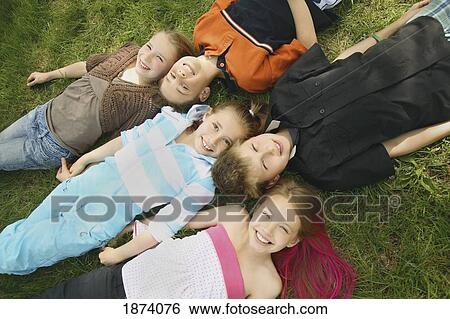 edmonton, alberta, canada; a group of children laying on the grass View Large Photo Image Stock Photograph - edmonton, alberta, canada; a group of children laying on the grass. Fotosearch