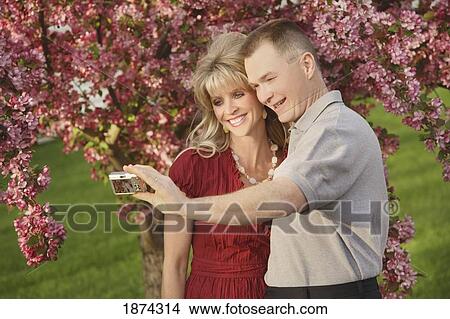Picture - edmonton, alberta, canada; a man and woman taking a picture of themselves with a camera. Fotosearch