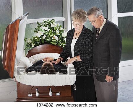edmonton, alberta, canada; a man and woman view the body of a deceased person in a coffin View Large Photo Image Stock Image - edmonton, alberta, canada; a man and woman view the body of a deceased person in a coffin. Fotosearch