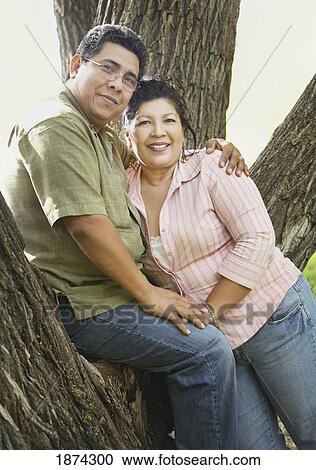 Stock Image - edmonton, alberta, canada; a man and woman leaning against a tree. Fotosearch