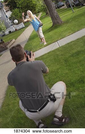 Picture - edmonton, alberta, canada; a man recording a girl talking. Fotosearch