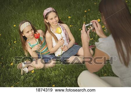 edmonton, alberta, canada; a mother takes a picture of her daughters holding tulips View Large Photo Image Stock Photo - edmonton, alberta, canada; a mother takes a picture of her daughters holding tulips. Fotosearch