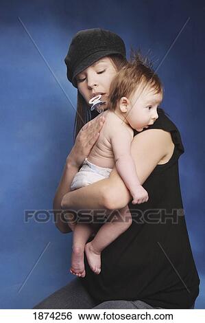 Stock Photograph - edmonton, alberta, canada; a mother holding her baby. Fotosearch