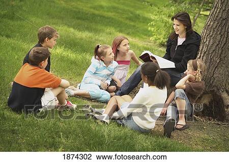 edmonton, alberta, canada; a woman teaches a group of children in a park View Large Photo Image Stock Image - edmonton, alberta, canada; a woman teaches a group of children in a park. Fotosearch