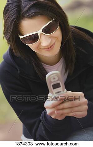 Stock Image - edmonton, alberta, canada; a woman uses her cell phone. Fotosearch