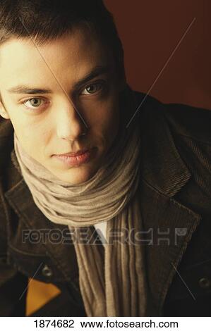 edmonton, alberta, canada; portrait of a young man wearing a scarf and jacket View Large Photo Image Stock Image - edmonton, alberta, canada; portrait of a young man wearing a scarf and jacket. Fotosearch