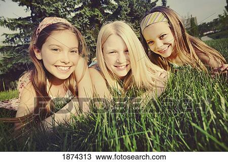 edmonton, alberta, canada; three girls laying on the grass View Large Photo Image Stock Image - edmonton, alberta, canada; three girls laying on the grass. Fotosearch