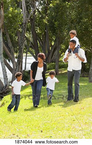 Picture - fort lauderdale, florida, united states of america; a family taking a walk in a park. Fotosearch