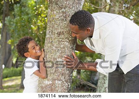 fort lauderdale, florida, united states of america; a father and son playing by a tree View Large Photo Image Picture - fort lauderdale, florida, united states of america; a father and son playing by a tree. Fotosearch