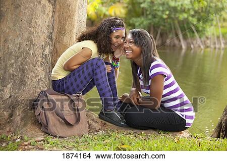 fort lauderdale, florida, united states of america; two teenage girls telling secrets View Large Photo Image Picture - fort lauderdale, florida, united states of america; two teenage girls telling secrets. Fotosearch