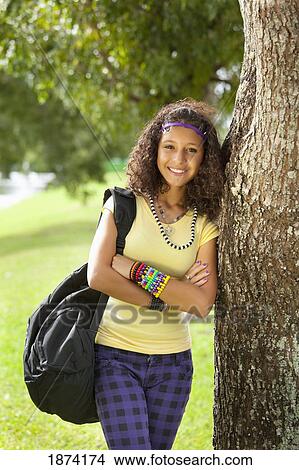 fort lauderdale, florida, united states of america; a teenage girl leaning against a tree View Large Photo Image Picture - fort lauderdale, florida, united states of america; a teenage girl leaning against a tree. Fotosearch