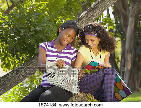 fort lauderdale, florida, united states of america; two teenage girls sitting in the park doing school work View Large Photo Image Picture - fort lauderdale, florida, united states of america; two teenage girls sitting in the park doing school work. Fotosearch