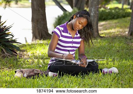 Picture - fort lauderdale, florida, united states of america; a teenage girl doing school work in a park. Fotosearch