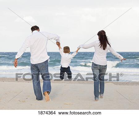 Picture - fort lauderdale, florida, united states of america; a family on the beach. Fotosearch