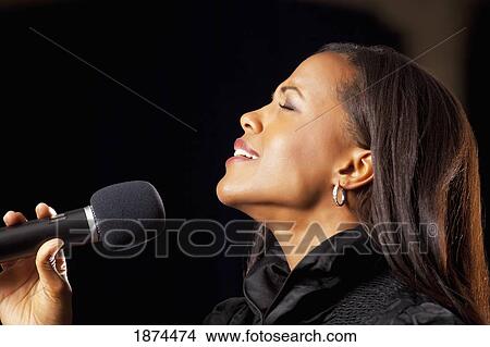 Picture - fort lauderdale, florida, united states of america; a woman singing into a microphone. Fotosearch