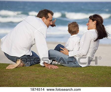 fort lauderdale, florida, united states of america; a family sitting on the grass by the ocean View Large Photo Image Picture - fort lauderdale, florida, united states of america; a family sitting on the grass by the ocean. Fotosearch