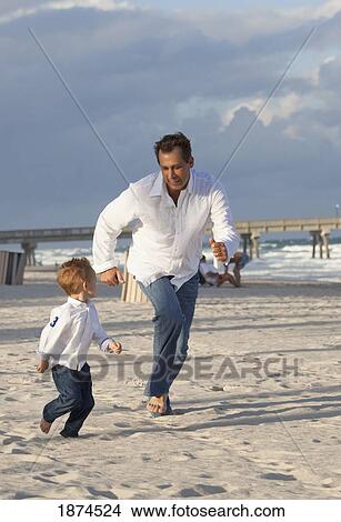 fort lauderdale, florida, united states of america; a father and his young son racing on the beach View Large Photo Image Picture - fort lauderdale, florida, united states of america; a father and his young son racing on the beach. Fotosearch