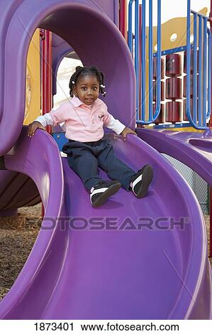 fort lauderdale, florida, united states of america; a young girl going down the slide at a playground View Large Photo Image Stock Image - fort lauderdale, florida, united states of america; a young girl going down the slide at a playground. Fotosearch