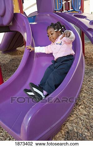 fort lauderdale, florida, united states of america; a young girl going down the slide at a playground View Large Photo Image Stock Image - fort lauderdale, florida, united states of america; a young girl going down the slide at a playground. Fotosearch