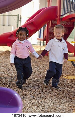 Stock Image - fort lauderdale, florida, united states of america; two young children playing at a playground. Fotosearch