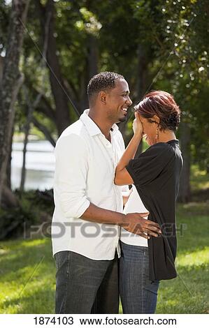 Stock Image - fort lauderdale, florida, united states of america; a couple laughing together in a park. Fotosearch