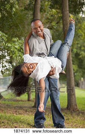 Stock Image - fort lauderdale, florida, united states of america; a couple having fun in a park. Fotosearch