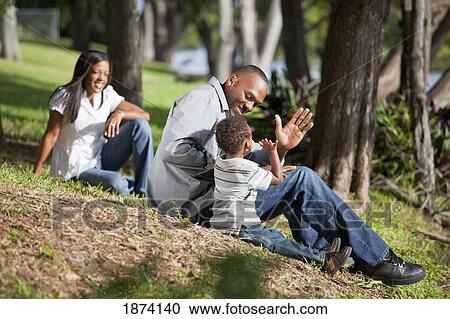 fort lauderdale, florida, united states of america; a father plays with his young son while the mother is watching View Large Photo Image Stock Image - fort lauderdale, florida, united states of america; a father plays with his young son while the mother is watching. Fotosearch