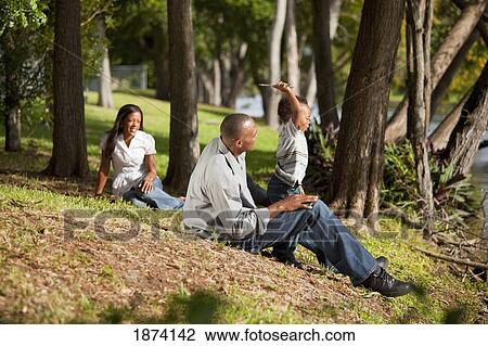fort lauderdale, florida, united states of america; a father plays with his young son in a park while the mother is watching View Large Photo Image Stock Image - fort lauderdale, florida, united states of america; a father plays with his young son in a park while the mother is watching. Fotosearch