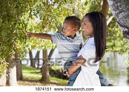 fort lauderdale, florida, united states of america; a mother holding her young son as he points to something View Large Photo Image Stock Image - fort lauderdale, florida, united states of america; a mother holding her young son as he points to something. Fotosearch