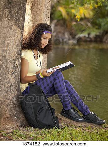 fort lauderdale, florida, united states of america; a girl reading a book under a tree View Large Photo Image Stock Image - fort lauderdale, florida, united states of america; a girl reading a book under a tree. Fotosearch