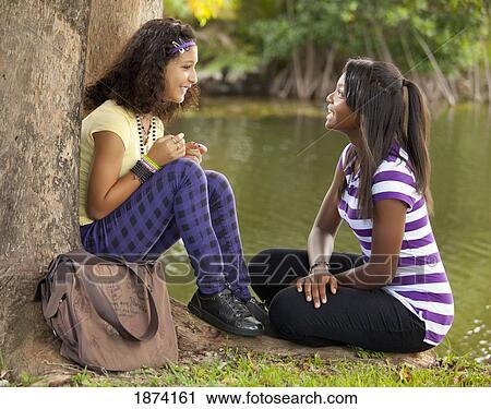 fort lauderdale, florida, united states of america; two girls talking while sitting under the trees View Large Photo Image Stock Image - fort lauderdale, florida, united states of america; two girls talking while sitting under the trees. Fotosearch
