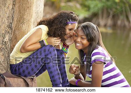 fort lauderdale, florida, united states of america; two teenage girls telling secrets View Large Photo Image Stock Image - fort lauderdale, florida, united states of america; two teenage girls telling secrets. Fotosearch