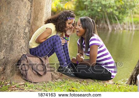fort lauderdale, florida, united states of america; two teenage girls telling secrets View Large Photo Image Stock Image - fort lauderdale, florida, united states of america; two teenage girls telling secrets. Fotosearch