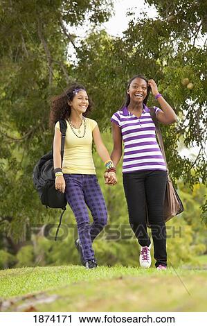 fort lauderdale, florida, united states of america; two teenage girls walking through a park with their school bags View Large Photo Image Stock Image - fort lauderdale, florida, united states of america; two teenage girls walking through a park with their school bags. Fotosearch