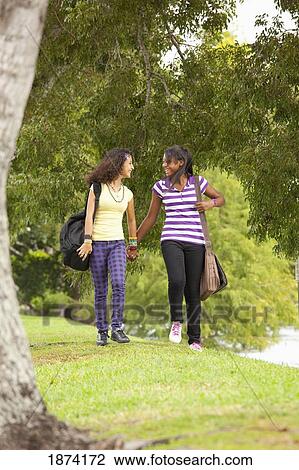 fort lauderdale, florida, united states of america; two teenage girls walking through a park with their school bags View Large Photo Image Stock Image - fort lauderdale, florida, united states of america; two teenage girls walking through a park with their school bags. Fotosearch
