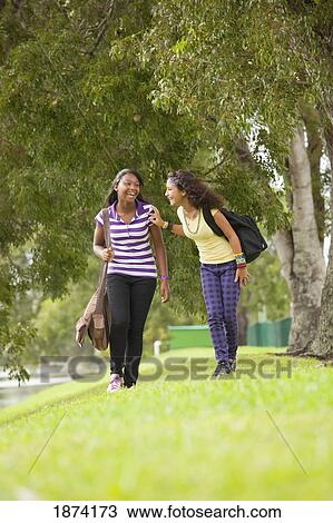 fort lauderdale, florida, united states of america; two teenage girls walking through a park with their school bags View Large Photo Image Stock Image - fort lauderdale, florida, united states of america; two teenage girls walking through a park with their school bags. Fotosearch