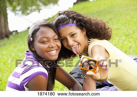 fort lauderdale, florida, united states of america; two teenage girls showing a picture of themselves View Large Photo Image Stock Image - fort lauderdale, florida, united states of america; two teenage girls showing a picture of themselves. Fotosearch
