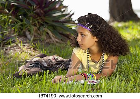 fort lauderdale, florida, united states of america; a teenage girl laying on the grass in a park with a book View Large Photo Image Stock Image - fort lauderdale, florida, united states of america; a teenage girl laying on the grass in a park with a book. Fotosearch
