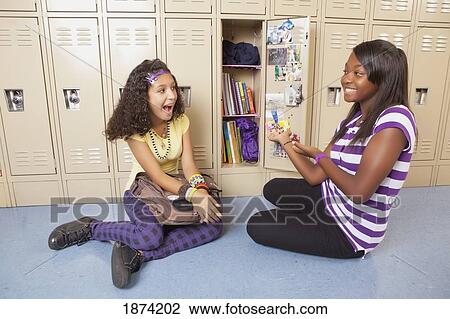 fort lauderdale, florida, united states of america; two teenage girls sitting at a locker in the school hallway View Large Photo Image Stock Image - fort lauderdale, florida, united states of america; two teenage girls sitting at a locker in the school hallway. Fotosearch