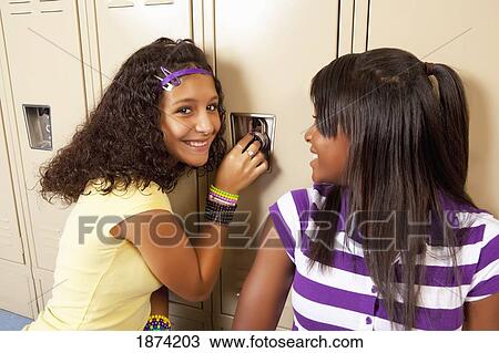 fort lauderdale, florida, united states of america; two teenage girls sitting in a school hallway and doing the combination lock on a locker View Large Photo Image Stock Image - fort lauderdale, florida, united states of america; two teenage girls sitting in a school hallway and doing the combination lock on a locker. Fotosearch