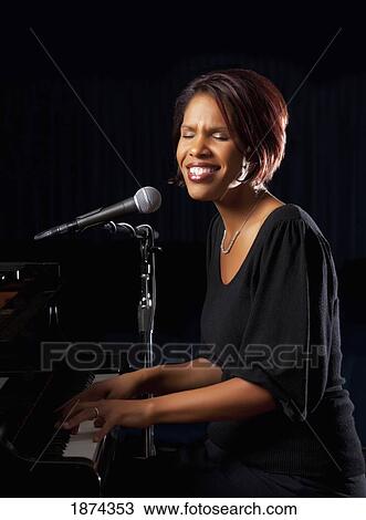 fort lauderdale, florida, united states of america; a woman singing into a microphone and playing the piano View Large Photo Image Stock Image - fort lauderdale, florida, united states of america; a woman singing into a microphone and playing the piano. Fotosearch