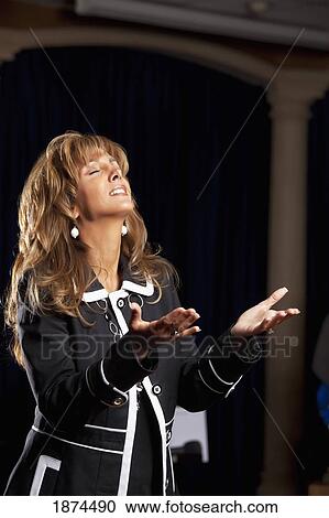 fort lauderdale, florida, united states of america; a woman singing with her hands raised in worship View Large Photo Image Stock Image - fort lauderdale, florida, united states of america; a woman singing with her hands raised in worship. Fotosearch