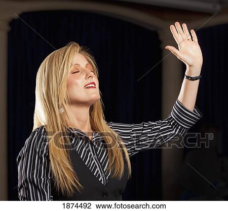 fort lauderdale, florida, united states of america; a woman with her hand raised in worship View Large Photo Image Stock Image - fort lauderdale, florida, united states of america; a woman with her hand raised in worship. Fotosearch