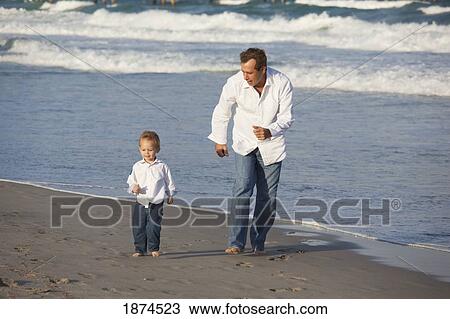 fort lauderdale, florida, united states of america; a father and son walking on the beach along the ocean View Large Photo Image Stock Image - fort lauderdale, florida, united states of america; a father and son walking on the beach along the ocean. Fotosearch