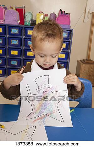 fort lauderdale, florida, united states of america; a young boy showing his coloring sheet while sitting at a table in a classroom View Large Photo Image Stock Photo - fort lauderdale, florida, united states of america; a young boy showing his coloring sheet while sitting at a table in a classroom. Fotosearch