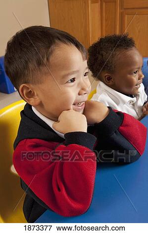 fort lauderdale, florida, united states of america; two young boys sitting at a table in a classroom View Large Photo Image Stock Photo - fort lauderdale, florida, united states of america; two young boys sitting at a table in a classroom. Fotosearch