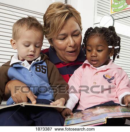 fort lauderdale, florida, united states of america; a teacher reads to two young children View Large Photo Image Stock Photo - fort lauderdale, florida, united states of america; a teacher reads to two young children. Fotosearch