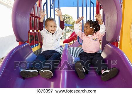 fort lauderdale, florida, united states of america; two young children going down the slide at a playground View Large Photo Image Stock Photo - fort lauderdale, florida, united states of america; two young children going down the slide at a playground. Fotosearch