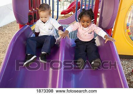 fort lauderdale, florida, united states of america; two young children going down the slide at a playground View Large Photo Image Stock Photo - fort lauderdale, florida, united states of america; two young children going down the slide at a playground. Fotosearch