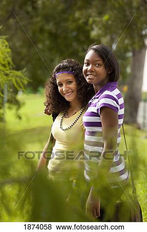 Stock Photo - fort lauderdale, florida, united states of america; two teenage girls together in a park. Fotosearch